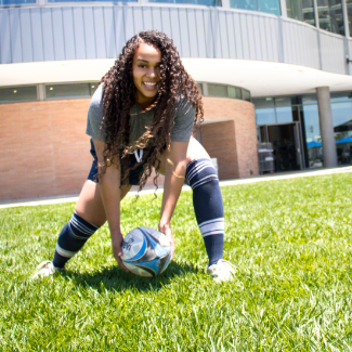female student with soccer ball