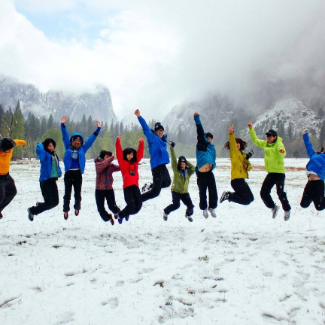 eleven students jumping in the snow