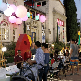 people painting outside the riverside art museum
