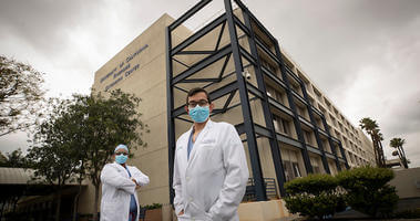 Dr. Garvin Patel, right, and his brother-n-law, Dr. Calvin Patel, standing in front of the UC Riverside Extension Center 